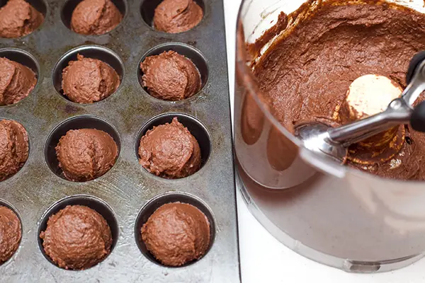 brownie batter placed in mini muffin tin