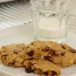 Plate with 3 cookies and 1/4 full glass of milk